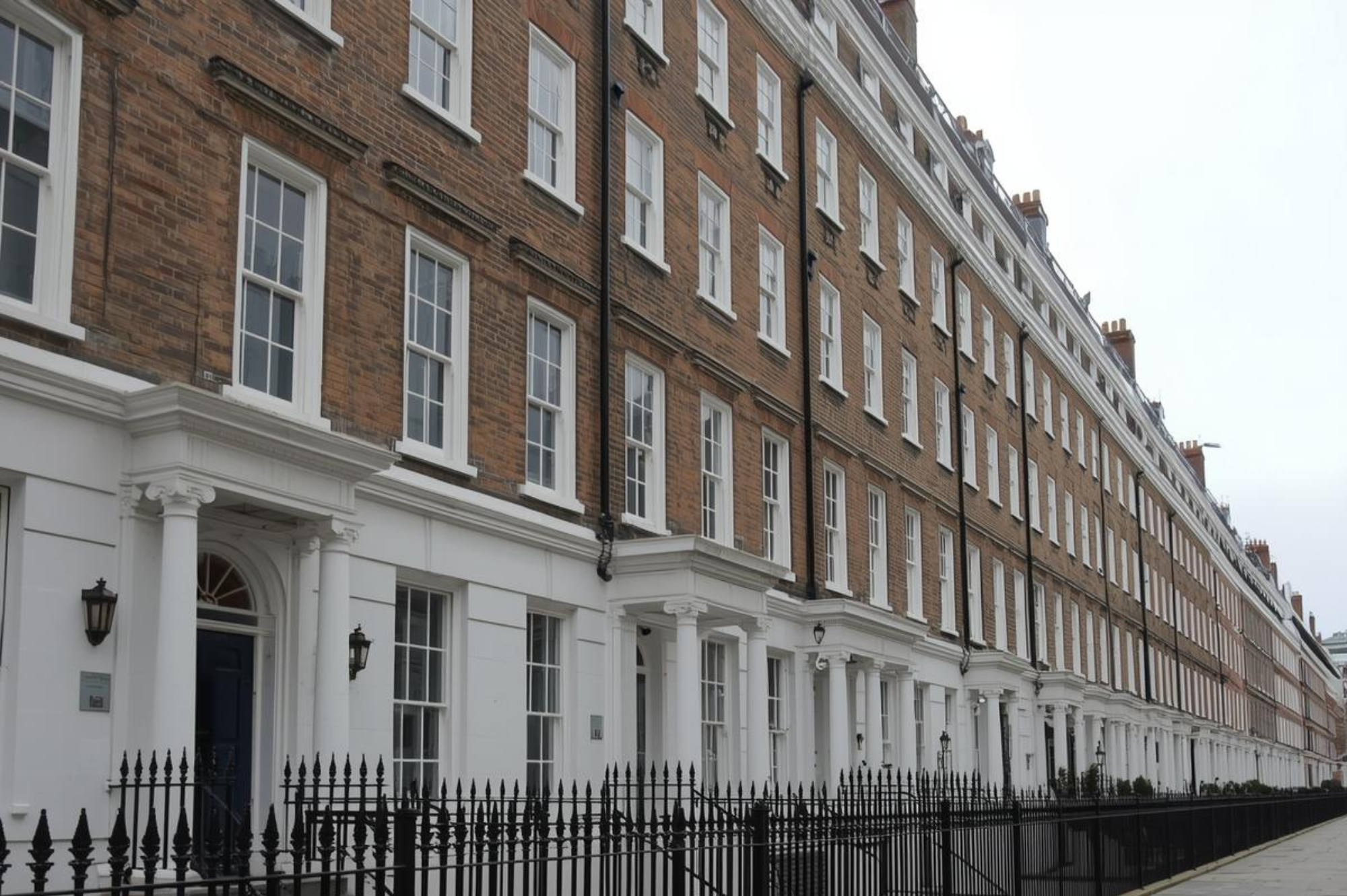 Grand Kensington townhouse with classic white stucco facade